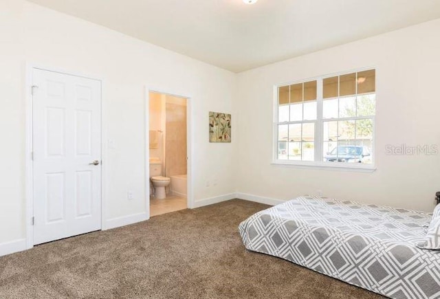 bedroom featuring connected bathroom and carpet flooring