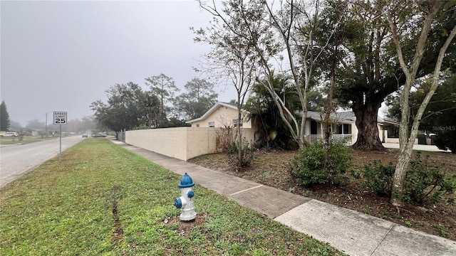 view of side of home with a yard