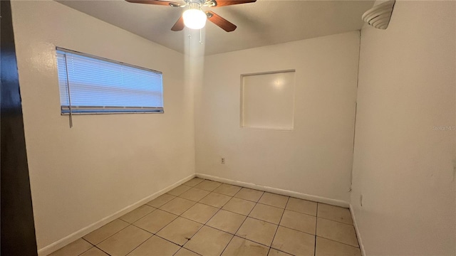 empty room featuring light tile patterned floors and ceiling fan