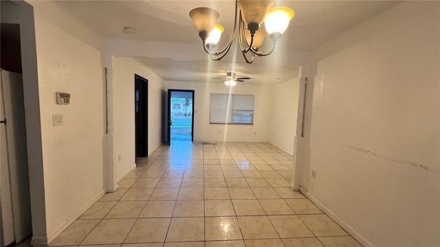 unfurnished dining area with light tile patterned floors and ceiling fan with notable chandelier