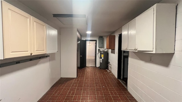 hallway with electric panel and water heater