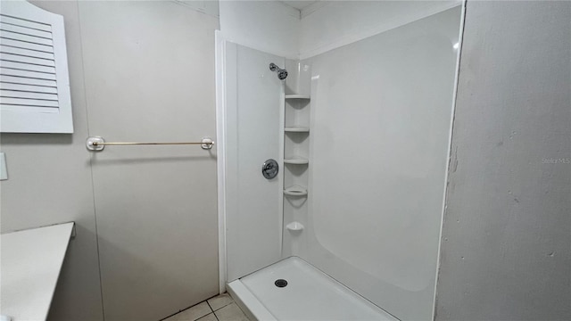 bathroom with tile patterned flooring and a shower