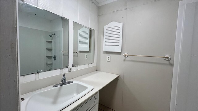 bathroom featuring vanity and a shower