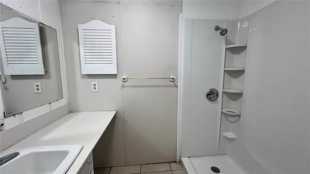 bathroom featuring vanity, a shower, and tile patterned floors