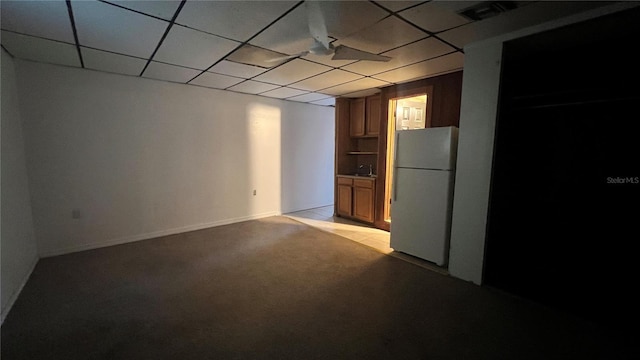 interior space featuring light carpet and a drop ceiling