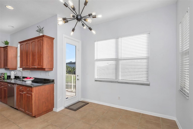 kitchen featuring light tile patterned floors, dishwasher, sink, and a notable chandelier