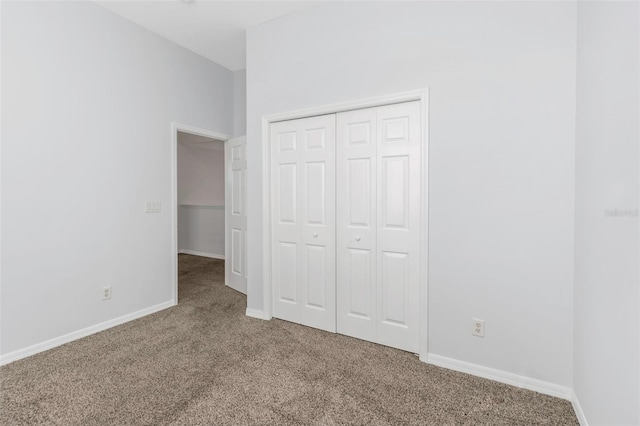 unfurnished bedroom with carpet flooring and a closet