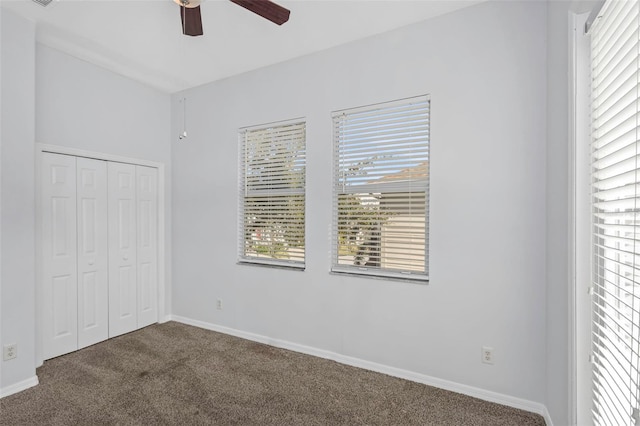 unfurnished bedroom with a closet, ceiling fan, and carpet flooring