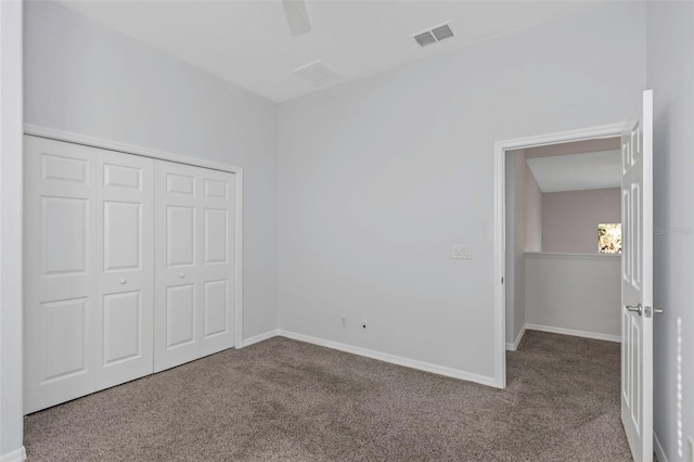 unfurnished bedroom with ceiling fan, a closet, and carpet