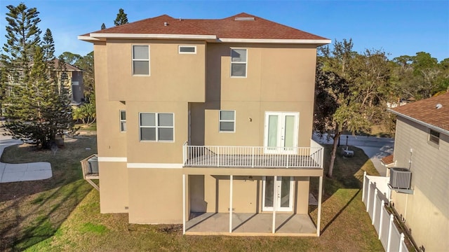 back of house featuring a yard, central AC unit, a patio area, french doors, and a balcony