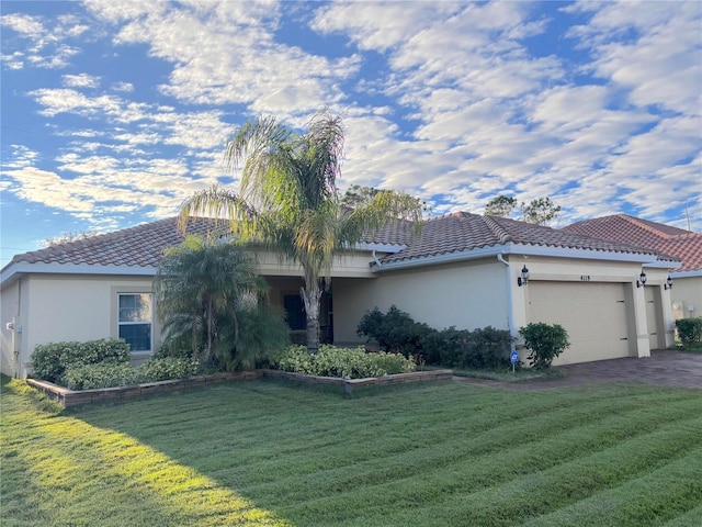 view of front of property with a garage and a front lawn