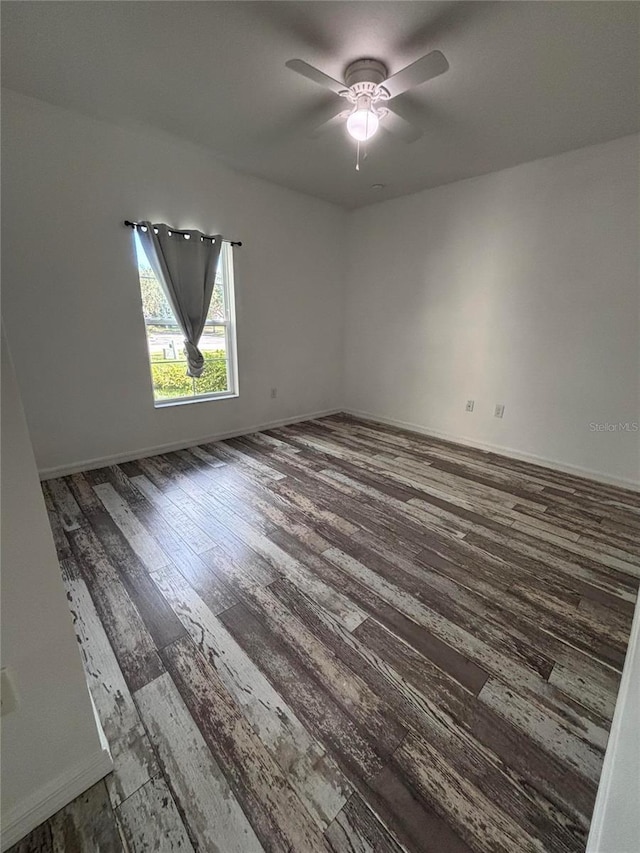 spare room featuring hardwood / wood-style floors and ceiling fan