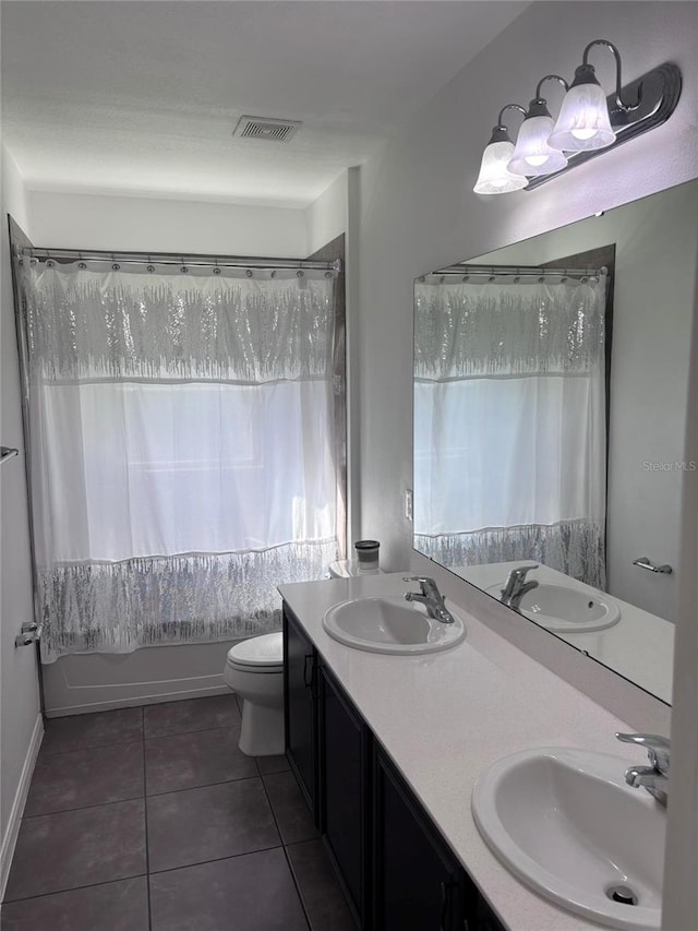 full bathroom with tile patterned flooring, vanity, tub / shower combination, and toilet