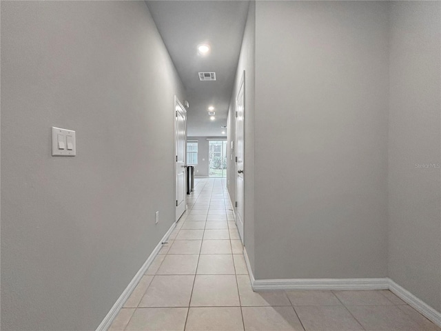 corridor with light tile patterned floors