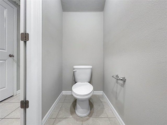 bathroom with tile patterned flooring and toilet