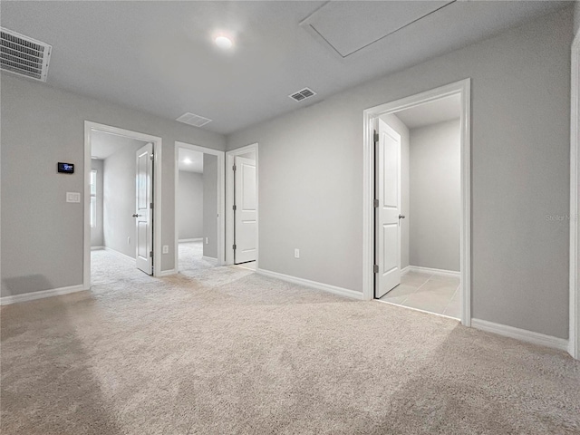 unfurnished bedroom featuring light carpet