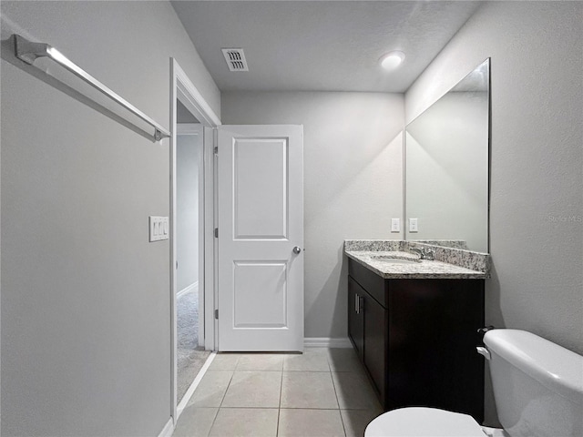 bathroom with tile patterned flooring, vanity, and toilet