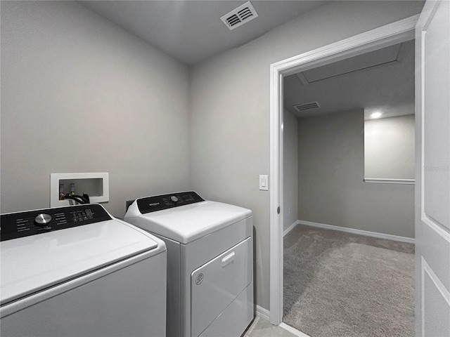 clothes washing area featuring washer and dryer and light colored carpet