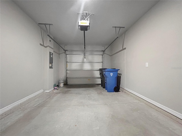 garage with a garage door opener and electric panel