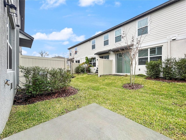 rear view of property featuring a lawn