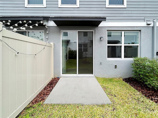 doorway to property featuring a lawn