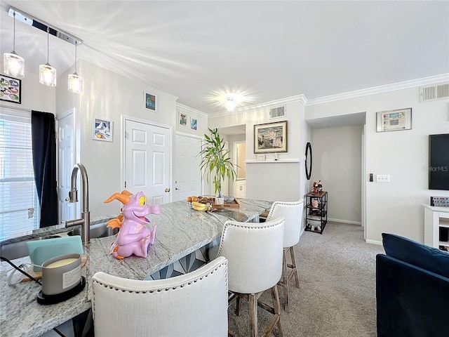 dining room with crown molding and carpet floors