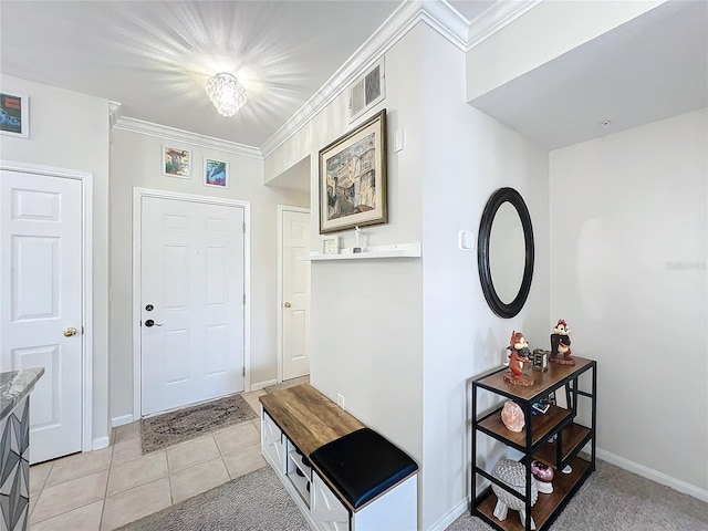 foyer entrance featuring crown molding and light tile patterned floors