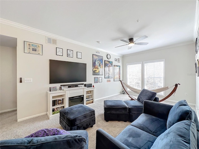 carpeted living room with ceiling fan and ornamental molding