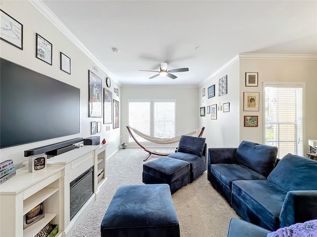 living room with crown molding, light colored carpet, and ceiling fan