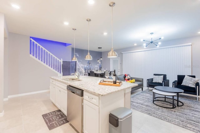 kitchen with pendant lighting, sink, dishwasher, a kitchen island with sink, and white cabinets