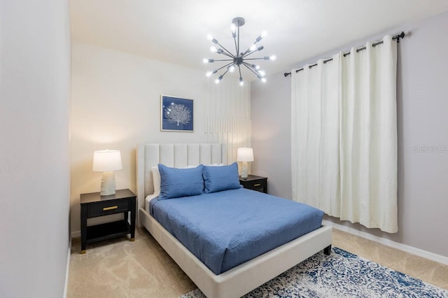 bedroom featuring light colored carpet and an inviting chandelier