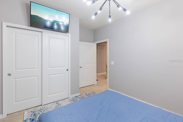 bedroom featuring light carpet and a closet