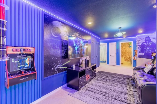 carpeted home theater room with a textured ceiling