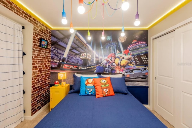 recreation room featuring brick wall and carpet flooring