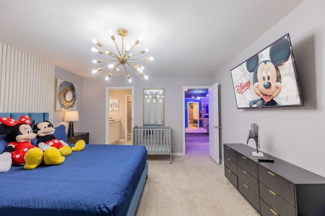 bedroom featuring connected bathroom, light colored carpet, and a chandelier