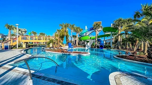 view of swimming pool with a water slide