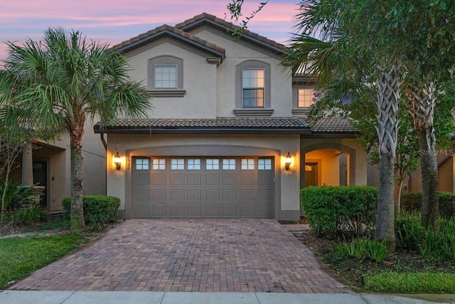 mediterranean / spanish-style house with a garage