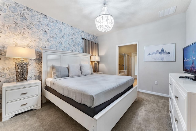 bedroom featuring ensuite bath, carpet, and a notable chandelier