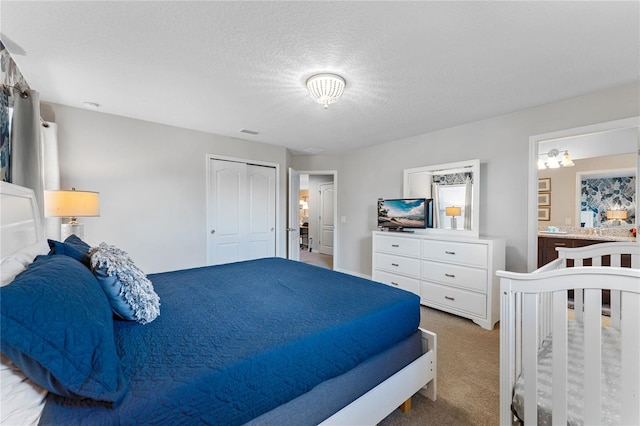 bedroom with carpet floors, a closet, and a textured ceiling