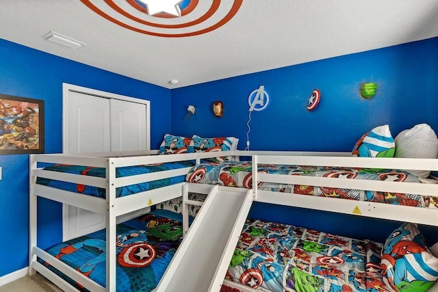 bedroom featuring carpet floors and a textured ceiling