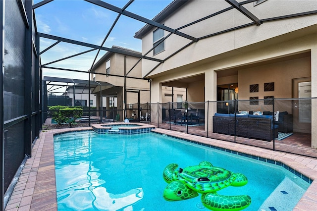 view of swimming pool featuring an in ground hot tub, outdoor lounge area, glass enclosure, and a patio area