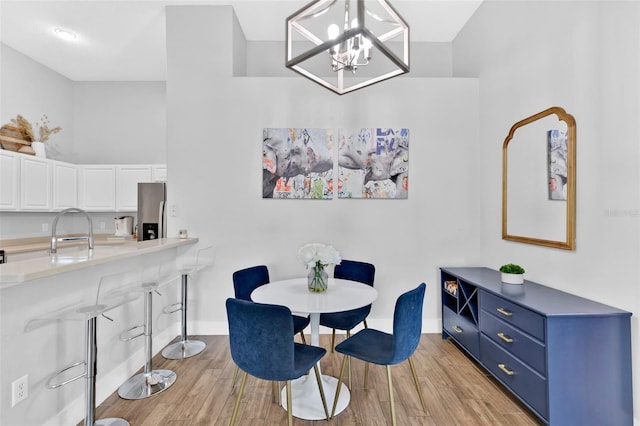 dining space featuring sink and light wood-type flooring