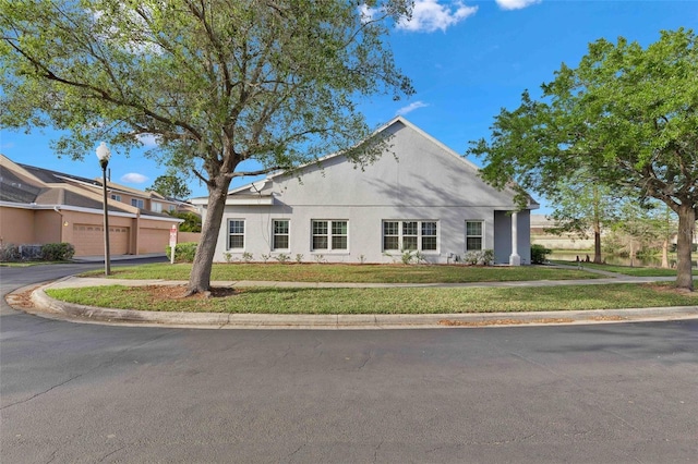 view of front of home with a garage and a front yard