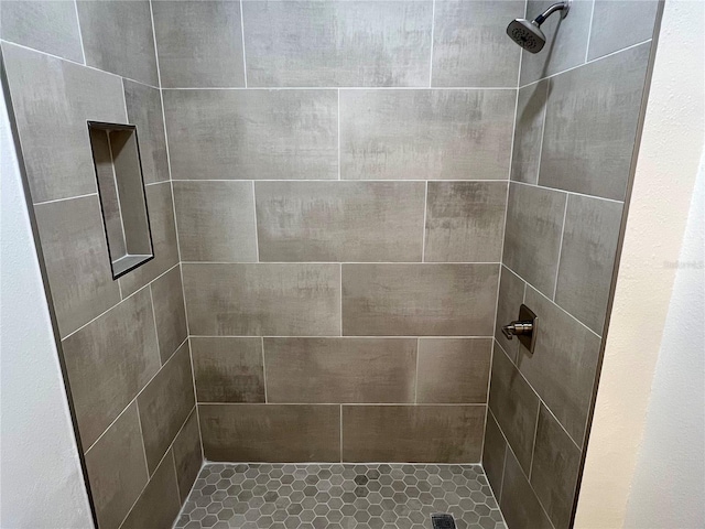 bathroom with a tile shower