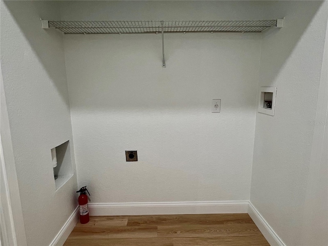 clothes washing area featuring wood-type flooring, washer hookup, and hookup for an electric dryer