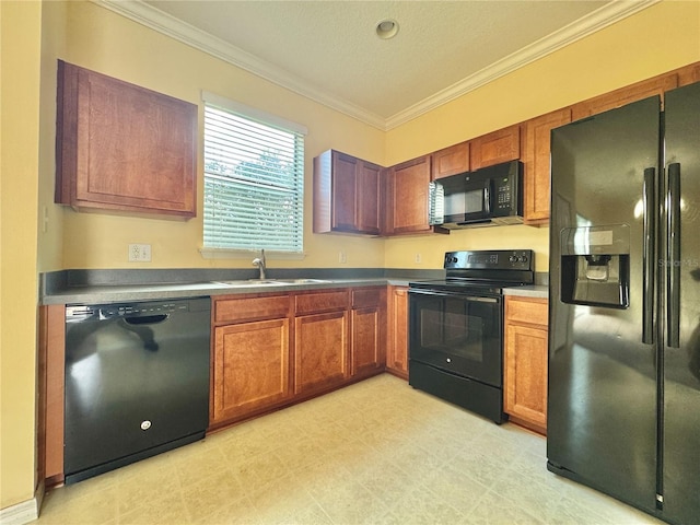 kitchen with ornamental molding, sink, and black appliances