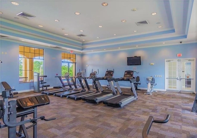 workout area featuring crown molding, a tray ceiling, french doors, and carpet flooring