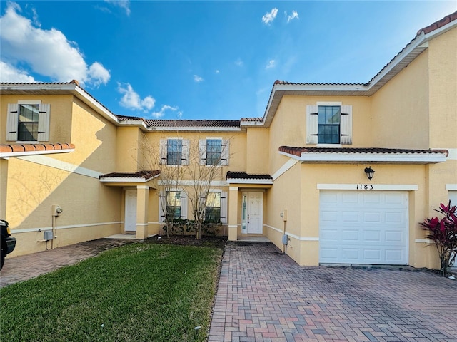 view of front of property with a garage and a front yard