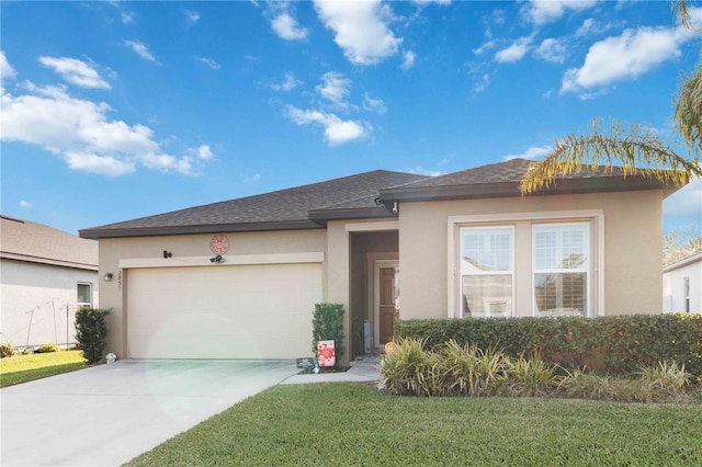 view of front of property with a garage and a front lawn