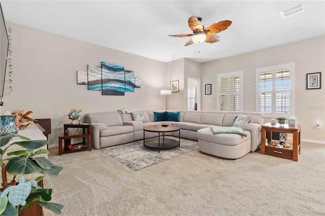 carpeted living room featuring ceiling fan